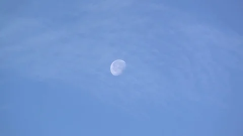 The moon appears in a blue sky Stock Footage 71718234