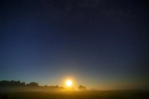 Moon on the background of the starry night sky. Stock Photos