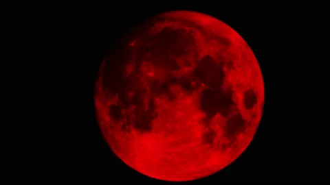 Moon becomes evil red moon aka blood moon filmed with a super tele lens in UHD Stock Footage 159727078