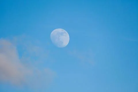 Moon behind cloud at blue sky Stock Photos