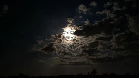 Moon behind the clouds Stock Photos