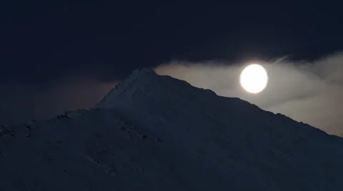 Moon behind the mountain and clouds, timelapse video Stock Footage