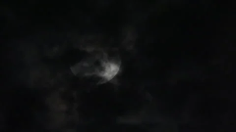 THE MOON BETWEEN DRAMATIC CLOUDS Stock Footage 289926831
