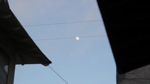 Moon between houses Stock Footage 47522189