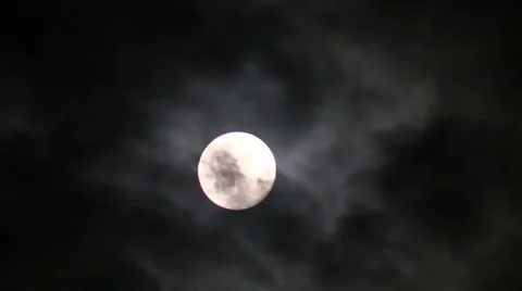 The moon on a black night sky and floating clouds Stock Footage 39798980