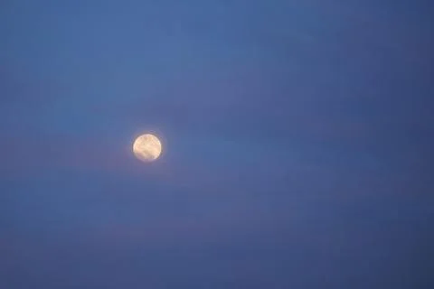 Moon at blue cloudy sky Stock Photos