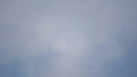 Moon on blue sky and cloud moving on daytime Stock Footage 129779852