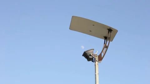 Moon is in the blue sky between the street lamp 스톡 동영상 131673554