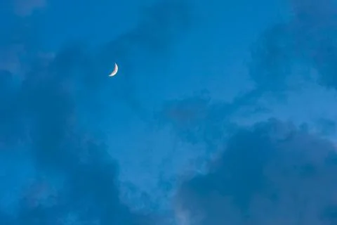 Moon on blue sky with clouds Stock Photos