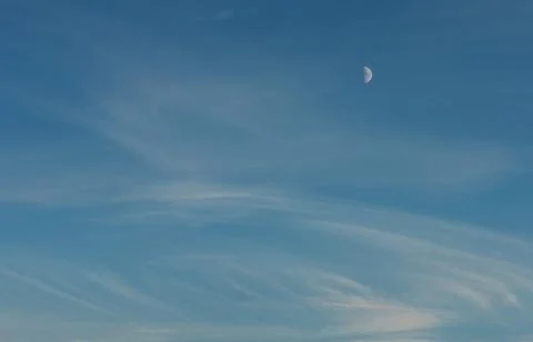 The moon in the blue sky when the sun is still setting. beautifully drawing from Stock Photos