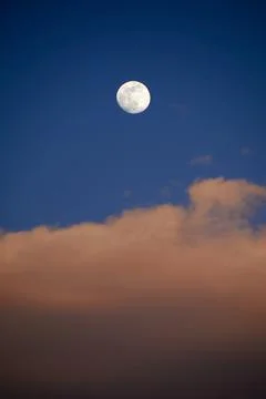 Moon in blue sky with white clouds Stock Photos