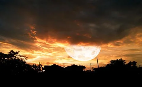 Moon in bright clouds of sunset sun . New moon , moon in the blue sky new moo Stock Photos