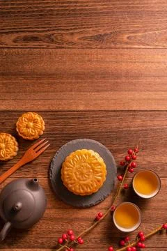 Moon cake Mooncake table setting - Chinese traditional pastry with tea cups.. Stock Photos