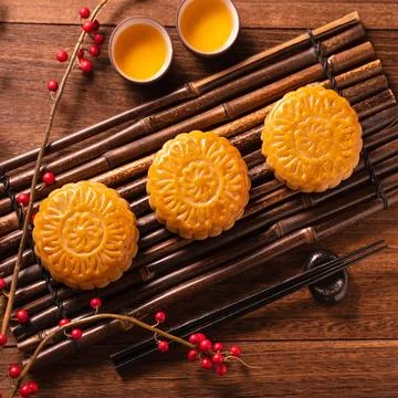 Moon cake Mooncake table setting - Chinese traditional pastry with tea cups.. Stock Photos