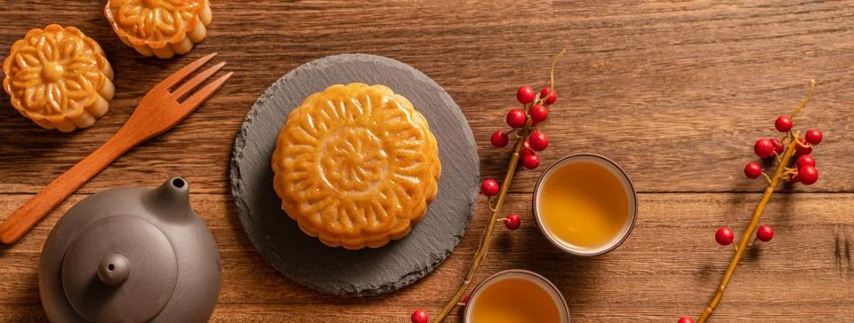 Moon cake Mooncake table setting - Chinese traditional pastry with tea cups.. Stock Photos