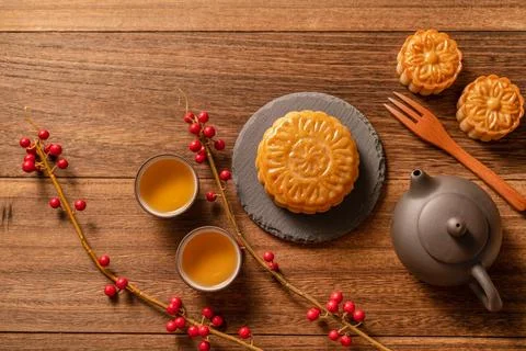 Moon cake Mooncake table setting - Chinese traditional pastry with tea cups.. Stock Photos