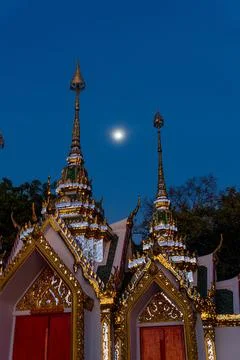 Moon caught between two Buddhist temple, in Ayutthaya, Thailand Stock Photos