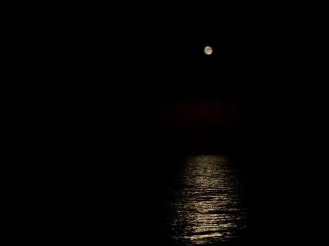 Moon causing reflections on the sea surface Stock Photos
