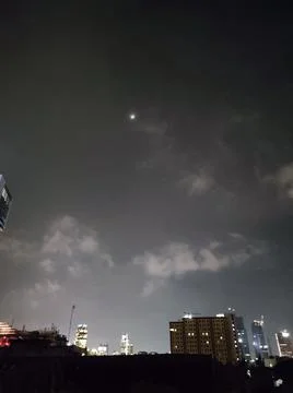 The moon in the city sky Stock Photos