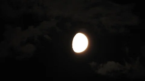 Moon with clouds moving on sky, 4k closeup video at night Stock Footage 99964775