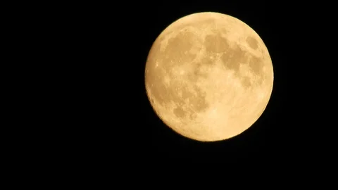 Moon with clouds moving on sky, 4k closeup video at night Stock Footage 99964814