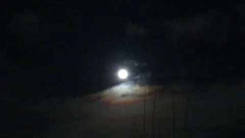 Moon in the clouds in the night sky 스톡 동영상 270510394