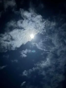 Moon in the cloudy night sky Stock Photos