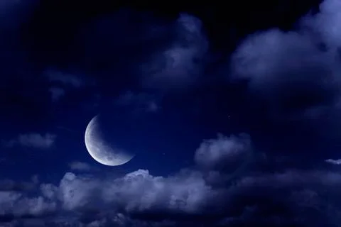 Moon in a cloudy sky Stock Photos
