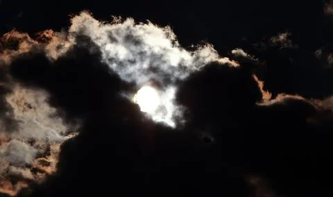 Moon coming out from behind clouds Stock Photos