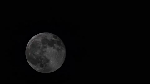 Moon is covered by fast moving clouds. Video stock 232598810