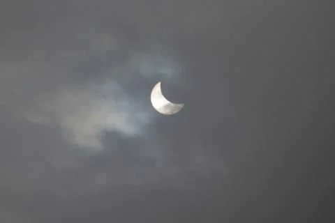 The Moon covering the Sun in a partial eclipse. Stock Photos