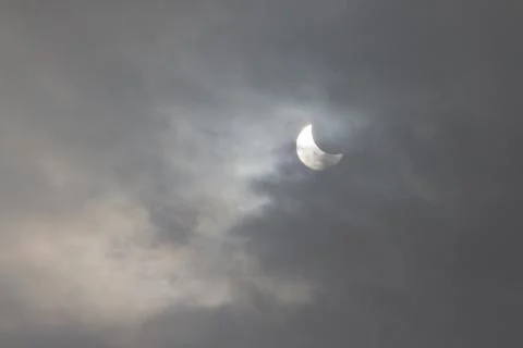The Moon covering the Sun in a partial eclipse. Stock Photos