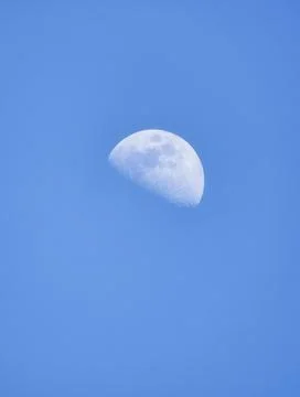 Moon with craters during the day against a blue sky Stock-Fotos