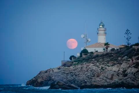 Moon eclipse over a lighthouse Fotos Stock