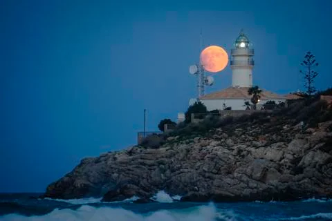 Moon eclipse over a lighthouse Fotos Stock
