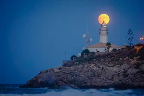 Moon eclipse over a lighthouse Fotos Stock