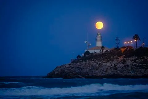 Moon eclipse over a lighthouse Fotos Stock