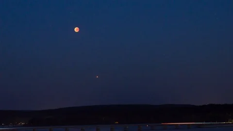 Moon eclipse over the Möhnesee Stock Footage 92963518