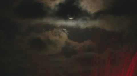 Moon emerges from clouds above a colored fountain Stock Footage 20553363