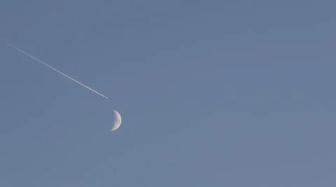 Moon Encounter Jet Airplane Passing Fuel Trail Against Blue Sky Aircraft Flight Video stock 41542851