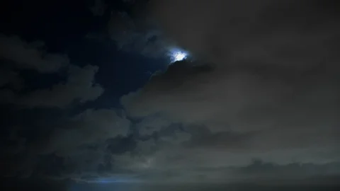 Moon fights billowing storm clouds night timelapse 8K Stock Footage 108394798