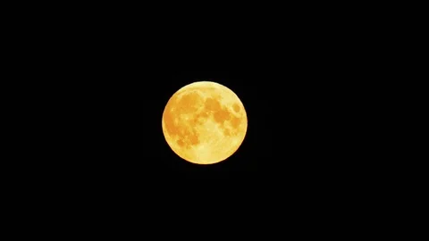 The moon is floating against the black sky. Stockbeeldmateriaal 112775332