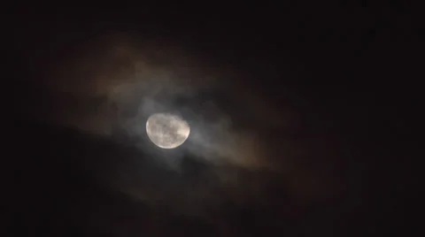 Moon goes dark behind clouds 2 Stock Footage 24637435