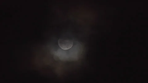 Moon goes dark behind clouds Stock Footage 24637489