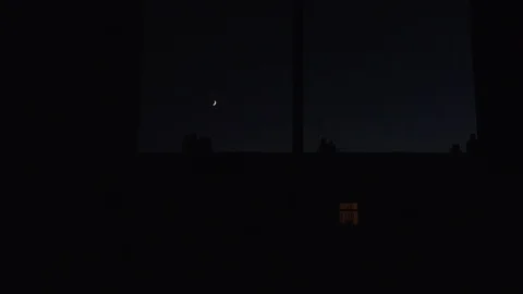 Moon going down small white spot in black UK 4K Stock Footage 121396820