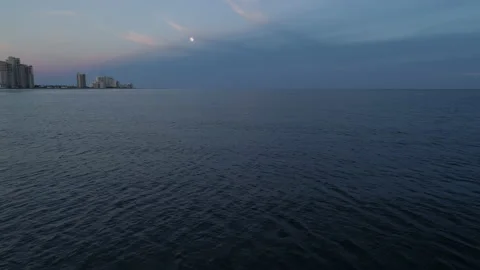 Moon Hanging Over the Ocean Waves at Dusk Stock Footage 136482540