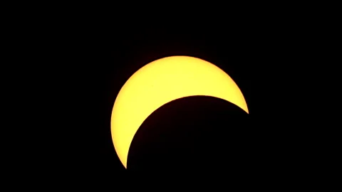 Moon moves slowly across the face of the sun during a solar eclipse. Stock Footage 272406496