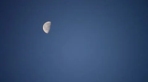 Moon moving across cloudless blue sky (200mm, 16x) Stock Footage 53444839