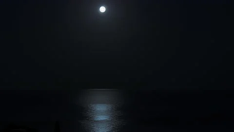 The moon moving across the sky clouds. Moonlight path on sea water at night Stock Footage 220300244