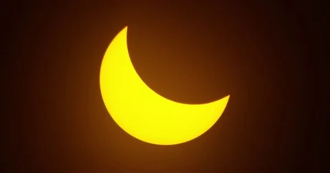 Moon moving across the sun during the solar eclipse as seen in the path of Stock Footage 81573289